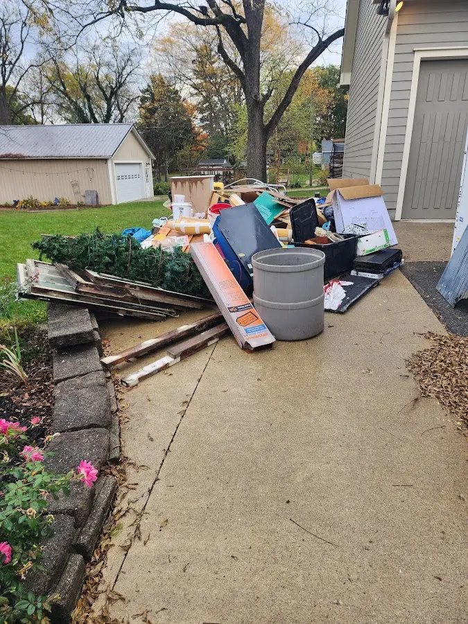 Dumpster being loaded with debris for 12 Yard Dumpster Rental in Rocklin